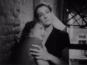 Movie still from “Bitter Rice” (1949), directed by Giuseppe De Santis – Two women are hugging each other in an old photo; Close Up shot, Low angle