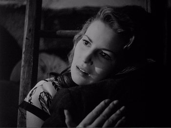 Movie still from “Bitter Rice” (1949), directed by Giuseppe De Santis – A beautiful woman holding a teddy bear in her arms; Close Up shot, Low angle