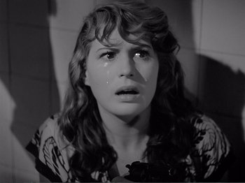 Movie still from “Bitter Rice” (1949), directed by Giuseppe De Santis – A young woman crying in a room with her eyes closed; Close Up shot, High angle