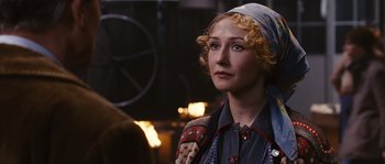 Movie still from “Black Book” (2006), directed by Paul Verhoeven – A woman with blonde curly hair wearing a blue scarf; Close Up shot, Over the shoulder angle