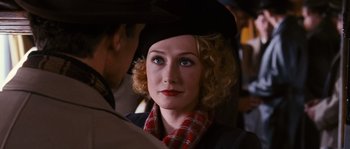 Movie still from “Black Book” (2006), directed by Paul Verhoeven – A person wearing a hat; Close Up shot, Over the shoulder angle