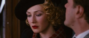 Movie still from “Black Book” (2006), directed by Paul Verhoeven – A person wearing a hat and lipstick; Close Up shot, High angle