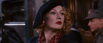 Movie still from “Black Book” (2006), directed by Paul Verhoeven – A person wearing a hat; Close Up shot, Over the shoulder angle