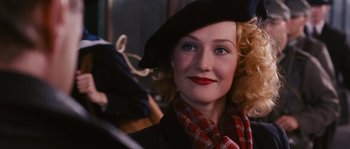 Movie still from “Black Book” (2006), directed by Paul Verhoeven – A person wearing a hat; Close Up shot, Over the shoulder angle