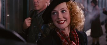 Movie still from “Black Book” (2006), directed by Paul Verhoeven – A person wearing a hat; Close Up shot, Over the shoulder angle