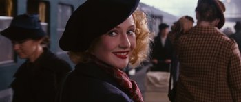 Movie still from “Black Book” (2006), directed by Paul Verhoeven – A woman in a black hat and a red scarf; Close Up shot, Over the shoulder angle