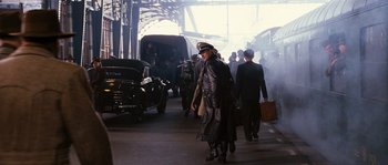 Movie still from “Black Book” (2006), directed by Paul Verhoeven – A group of people walking down a street; Wide shot, Over the shoulder angle