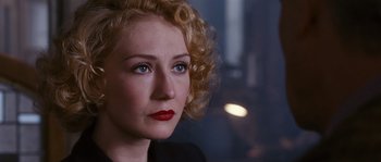 Movie still from “Black Book” (2006), directed by Paul Verhoeven – A person with curly hair; Close Up shot, Over the shoulder angle