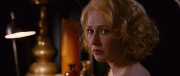 Movie still from “Black Book” (2006), directed by Paul Verhoeven – A person with blonde curly hair; Close Up shot, Over the shoulder angle