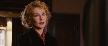 Movie still from “Black Book” (2006), directed by Paul Verhoeven – A woman with blonde curly hair wearing a black jacket; Close Up shot, Over the shoulder angle