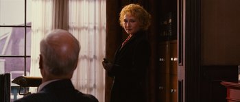 Movie still from “Black Book” (2006), directed by Paul Verhoeven – A woman standing in front of a window; Medium shot, Over the shoulder angle