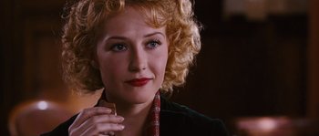 Movie still from “Black Book” (2006), directed by Paul Verhoeven – A person holding a glass of wine; Close Up shot, Over the shoulder angle