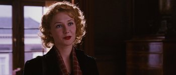 Movie still from “Black Book” (2006), directed by Paul Verhoeven – A woman with blonde curly hair wearing a black jacket; Close Up shot, Over the shoulder angle