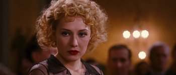 Movie still from “Black Book” (2006), directed by Paul Verhoeven – A person with curly blonde hair; Close Up shot, Over the shoulder angle