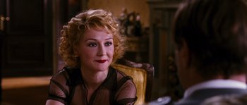 Movie still from “Black Book” (2006), directed by Paul Verhoeven – A woman sitting in a chair wearing a black shirt; Close Up shot, Over the shoulder angle