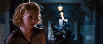 Movie still from “Black Book” (2006), directed by Paul Verhoeven – A woman standing in a room with a group of people; Close Up shot, Low angle