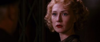 Movie still from “Black Book” (2006), directed by Paul Verhoeven – A person with blonde curly hair; Close Up shot, Over the shoulder angle