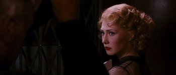 Movie still from “Black Book” (2006), directed by Paul Verhoeven – A woman with red hair and blue eyes looking into the distance; Close Up shot, Over the shoulder angle