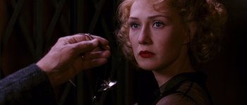 Movie still from “Black Book” (2006), directed by Paul Verhoeven – A woman holding a wine glass in front of her face; Close Up shot, Over the shoulder angle