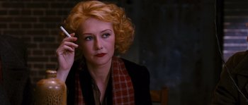 Movie still from “Black Book” (2006), directed by Paul Verhoeven – A woman with blonde curly hair wearing a red scarf; Close Up shot, Over the shoulder angle