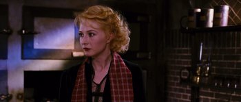 Movie still from “Black Book” (2006), directed by Paul Verhoeven – A woman wearing a red and black scarf; Close Up shot, Over the shoulder angle