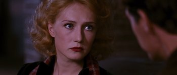 Movie still from “Black Book” (2006), directed by Paul Verhoeven – A person wearing a black shirt; Close Up shot, Over the shoulder angle