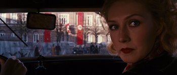 Movie still from “Black Book” (2006), directed by Paul Verhoeven – A woman is looking out of the window of a car; Close Up shot, Over the shoulder angle