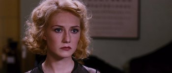 Movie still from “Black Book” (2006), directed by Paul Verhoeven – A person with blonde curly hair; Close Up shot, Over the shoulder angle