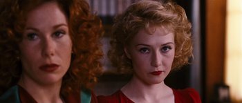 Movie still from “Black Book” (2006), directed by Paul Verhoeven – A woman in a red shirt and a woman in a red dress; Close Up shot, Over the shoulder angle