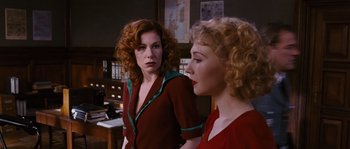 Movie still from “Black Book” (2006), directed by Paul Verhoeven – Two women are standing next to each other in a room; Medium shot, Over the shoulder angle