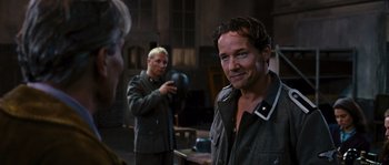 Movie still from “Black Book” (2006), directed by Paul Verhoeven – A man in a green jacket is looking at another man in a gray jacket; Medium shot, Over the shoulder angle