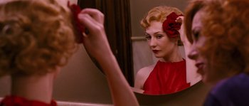 Movie still from “Black Book” (2006), directed by Paul Verhoeven – A woman in a red dress looking in a mirror; Close Up shot, Over the shoulder angle