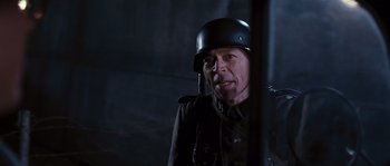 Movie still from “Black Book” (2006), directed by Paul Verhoeven – A man wearing a german helmet and a uniform; Close Up shot, Low angle