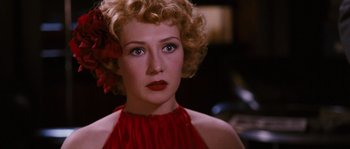 Movie still from “Black Book” (2006), directed by Paul Verhoeven – A person wearing a red dress; Close Up shot, Over the shoulder angle