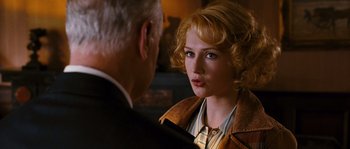 Movie still from “Black Book” (2006), directed by Paul Verhoeven – A woman with blonde curly hair is talking to an older man; Close Up shot, Over the shoulder angle