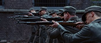 Movie still from “Black Book” (2006), directed by Paul Verhoeven – A group of men in uniform are holding rifles; Medium shot, High angle