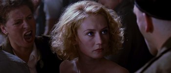 Movie still from “Black Book” (2006), directed by Paul Verhoeven – A person with curly blonde hair; Close Up shot, Over the shoulder angle