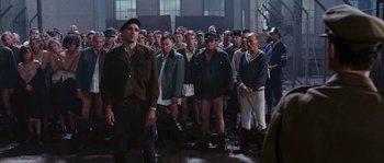 Movie still from “Black Book” (2006), directed by Paul Verhoeven – A large group of men standing together in a building; Wide shot, High angle