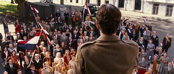 Movie still from “Black Book” (2006), directed by Paul Verhoeven – A crowd of people are gathered around a man in a military uniform; Wide shot, High angle
