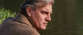 Movie still from “Black Book” (2006), directed by Paul Verhoeven – A person wearing a jacket; Close Up shot, Low angle