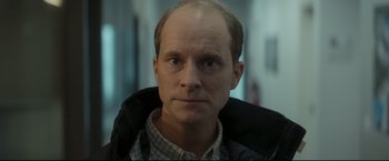 Movie still from “Black Box” (2021), directed by Yann Gozlan – A person wearing a jacket; Close Up shot, Low angle