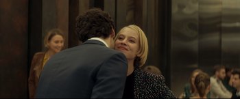 Movie still from “Black Box” (2021), directed by Yann Gozlan – A man and a woman are hugging and smiling for the camera; Close Up shot, Over the shoulder angle