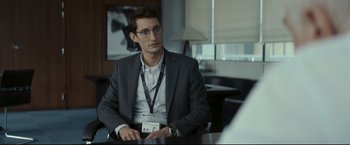 Movie still from “Black Box” (2021), directed by Yann Gozlan – A man sitting at a table in front of a mirror; Medium shot, Over the shoulder angle