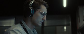 Movie still from “Black Box” (2021), directed by Yann Gozlan – A person wearing a pair of headphones; Close Up shot, Low angle
