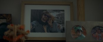 Movie still from “Black Box” (2021), directed by Yann Gozlan – A man and a woman taking a selfie in a picture frame; Extreme Close Up shot, Overhead angle