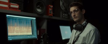 Movie still from “Black Box” (2021), directed by Yann Gozlan – A man in a recording studio with headphones on; Close Up shot, Over the shoulder angle