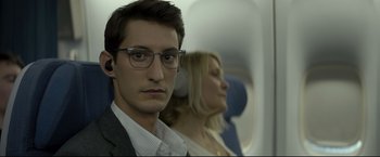 Movie still from “Black Box” (2021), directed by Yann Gozlan – A man and a woman sitting on a plane; Close Up shot, Over the shoulder angle