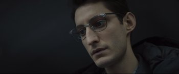 Movie still from “Black Box” (2021), directed by Yann Gozlan – A person wearing glasses; Close Up shot, Low angle