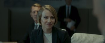 Movie still from “Black Box” (2021), directed by Yann Gozlan – A person wearing a suit; Close Up shot, Over the shoulder angle