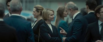 Movie still from “Black Box” (2021), directed by Yann Gozlan – A group of people standing next to each other talking; Medium shot, Over the shoulder angle